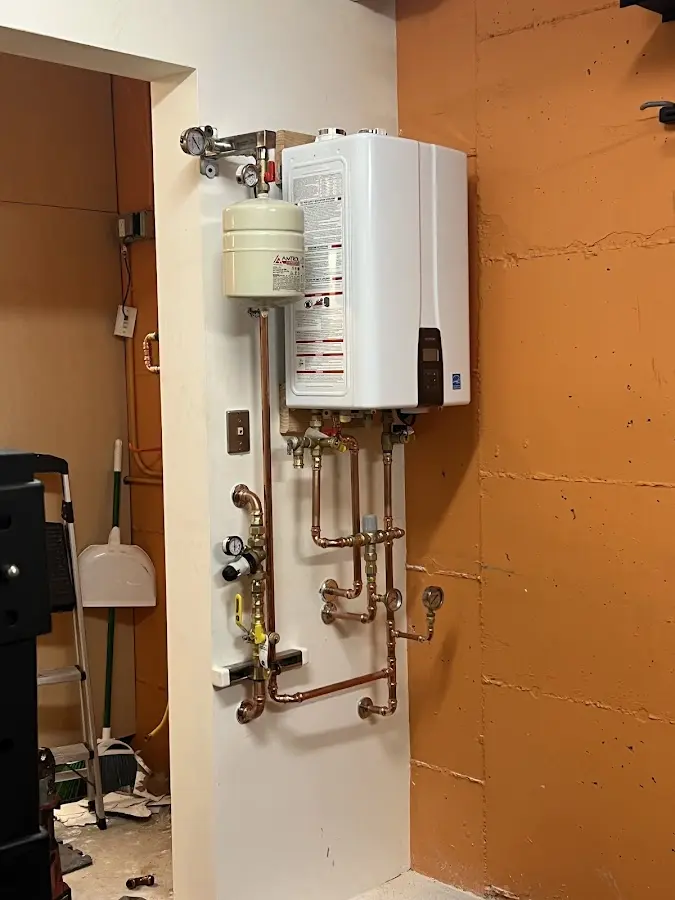 Plumbing technician inspecting water heater connections in Lago Vista